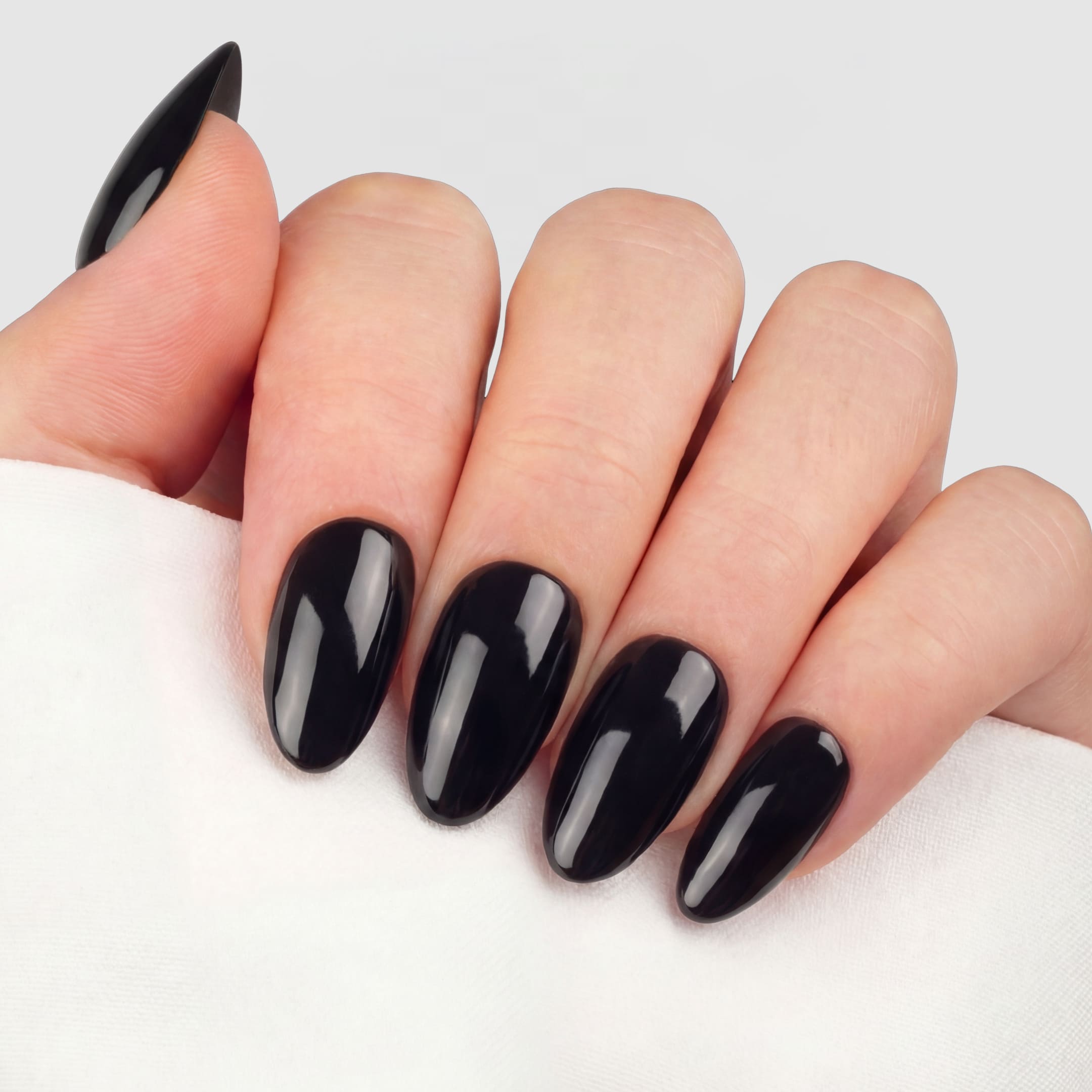 Svarta press-on lösnaglar i almondform med spegelblank finish och tidlös look. Återanvändbara naglar som håller upp till 2 veckor med lim eller glue tabs.